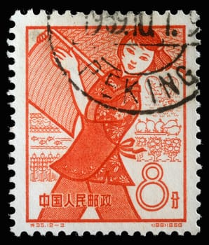 Stamp issued in the China shows Farming, the 1st Anniversary of People's Communes, circa 1959.