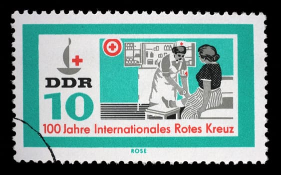 Stamp issued in Germany - Democratic Republic (DDR) shows Red Cross nurse, 100 years International Red Cross series, circa 1963.