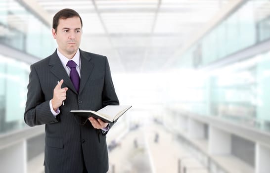 pensive businessman with a book at the office