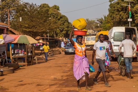 Bissau, Republic of Guinea-Bissau - January 6, 2020: Street scene in the city of Bissau with people at the street market, Guinea Bissau