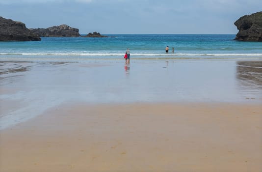 Llanes, Picos de Europa, Spain - June 2, 2018: People at the beach of Barro, Llanes, Asturias, Spain