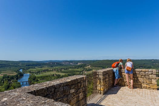 Domme, France - August 14, 2019:Tourists visiting the medieval town of Domme. Located in the Dordogne departement, occupies a splendid position high above the Dordogne valley, France.