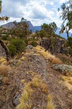 Hiker walking along the edge in the top of Simien mountains trail, First person point of View. Semien Mountain, Ethiopia wilderness, Africa