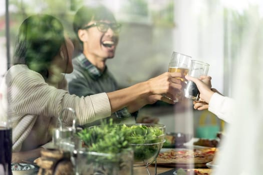 Happy asian multigenerational family of dad mom daughter girl and grandfather cheers together during lunch meal together with joyful. Happy family engagement togetherness concept. Taken outside window