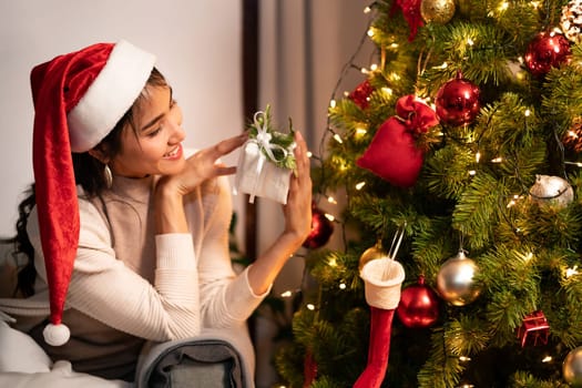 Beautiful asian woman holding Christmas ornament for decorate on christmas tree preparing for season greeting of merry christmas and happy holiday.