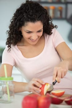 women are cutting apples in the kitchen