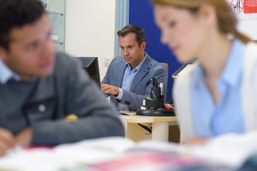 teacher in business technology classroom
