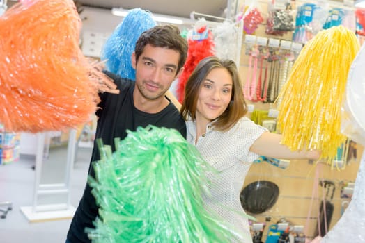 portrait of happy couple having fun trying costumes