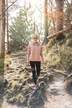 Young fit woman hiking in nature. Adventure, sport and exercise.