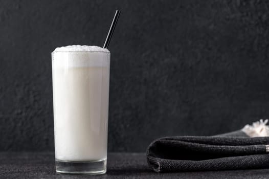 Glass of Ramos Gin Fizz Cocktail on dark background