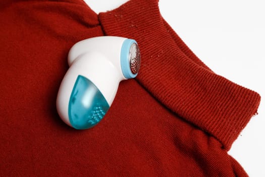 Device for removing lint from wool clothes. Golf with fuzz ball isolated on white background