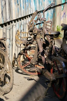 Old rusty rental bicycles taken out of the river Spree on the banks of the river in Berlin