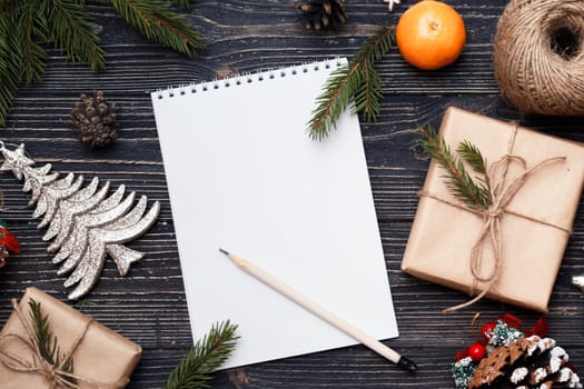 Letter to Santa Claus, Christmas gifts on dark wooden background.