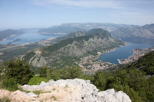 Panorama UNESCO World Heritage Site bay of Kotor with high mountains plunge into Adriatic sea and Historic town of Kotor, Montenegro