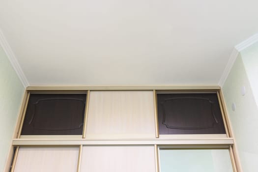The mezzanine of the wardrobe close-up in the interior of the bedroom