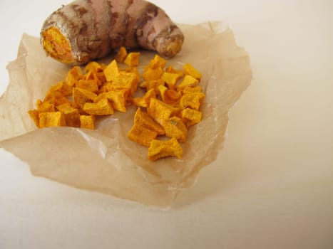 Dried turmeric, curcuma root in wax paper