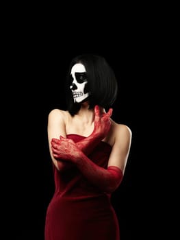 woman of Caucasian appearance dressed in a red velvet dress, long fishnet gloves. Halloween Skeleton Makeup, Black Background