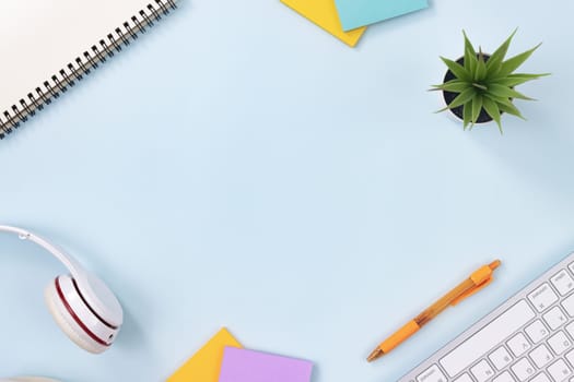 Top View Office Desk or Office Table and Stationery as Keyboard,Headphone,Pen,Stick Note,Spiral Notebook,Office Plants