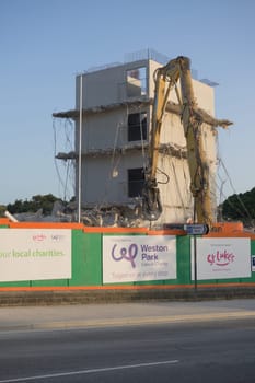 SHEFFIELD, UNITED KINGDOM, 17th September, 2020: Vertical image of large excavator concrete crusher off whitham road, demolishing subsided social hub