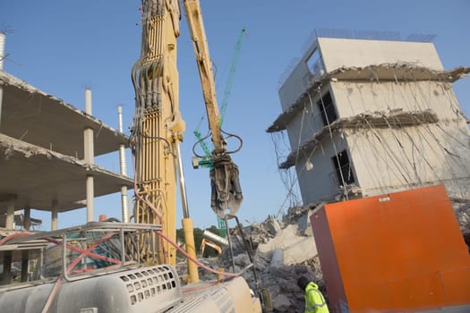 SHEFFIELD, UNITED KINGDOM, 17th September, 2020: Demolition site of the subsided university social sciences hub. Close up of excavator and workman