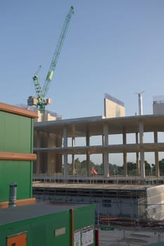SHEFFIELD, UNITED KINGDOM, 17th September, 2020: Vertical image of BAM crane and construction offices at the new UOS social sciences hub. Sunrise.