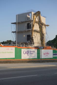 SHEFFIELD, UNITED KINGDOM, 17th September, 2020: High level demolition of sheffield university social sciences hub, using excavator concrete crusher