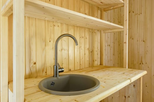 Kitchen set in a country house, worktop and walls made of natural wood