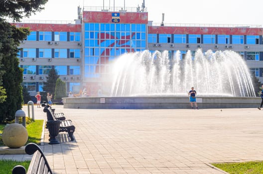 Anapa, Russia - 17 September 2020: The building of the administration of the resort city of Anapa and the fountain in the square in front of the building