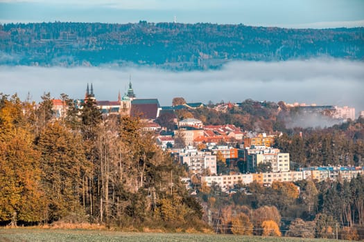view of the city of Jihlava with Church of St. James the Greater. Autumn fall season with mist. Vysocina, Czech Republic