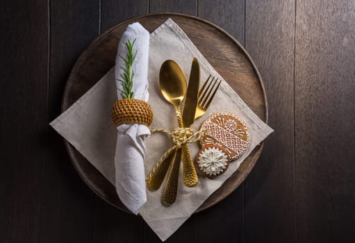 Christmas table place setting with vintage silverware and gingerbread. Christmas dining concept background.