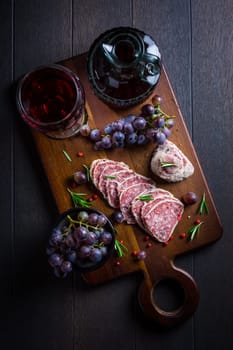 Saltufo - Italian salami delicacy, salami with summer truffle coated with Parmesan cheese with red wine and grapes