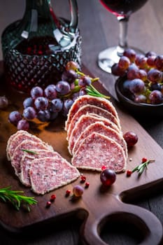 Saltufo - Italian salami delicacy, salami with summer truffle coated with Parmesan cheese with red wine and grapes