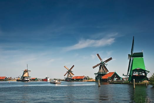 Windmills in Holland on the shore on sunny day