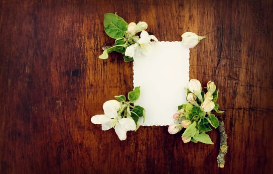 white paper with flowers on wooden surface