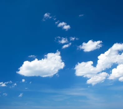 Fluffy clouds on the blue sky at sunny day