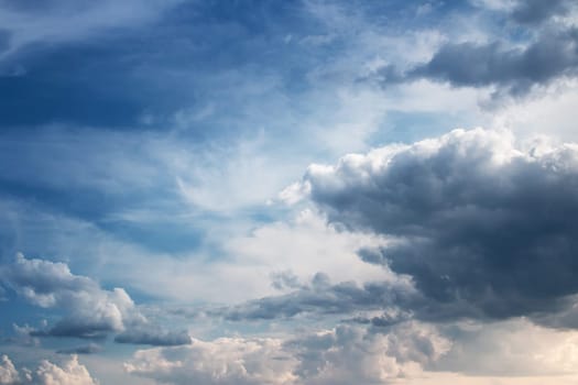 Dramatic clouds on the blue sky on sunny day