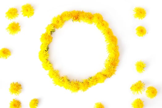 Round frame made of dandelions flowers. Summer concept, top view, flat lay.