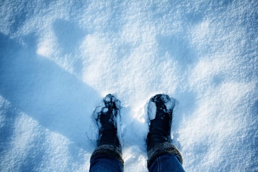 Feet on the snow outdoors on frosty winter