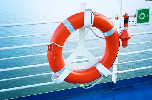 lifebelt on ferry with blue sea at the backdrop