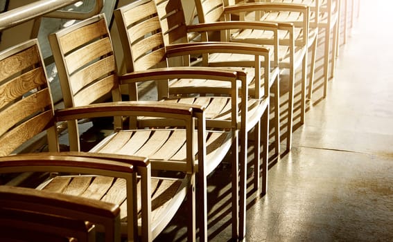 row of chairs in sunlight on the ferry
