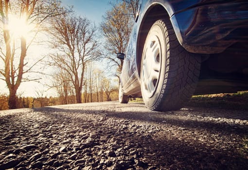 Car on asphalt road in early spring morning