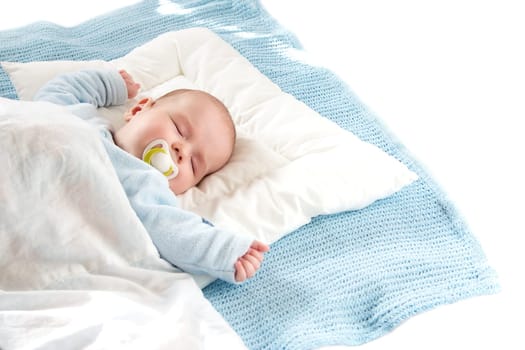 Four month old baby sleeping on blue blanket
