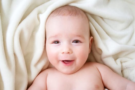 little boy sleeping on soft white blanket