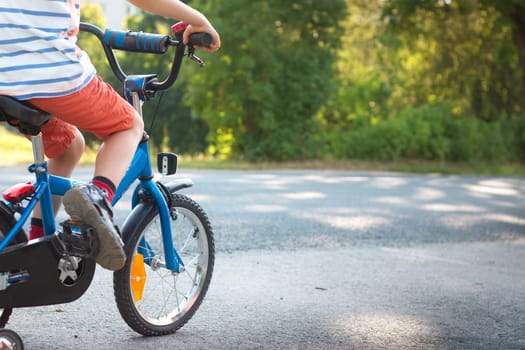 child on a bicycle at asphalt road