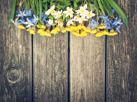 different sring flowers on old wooden background