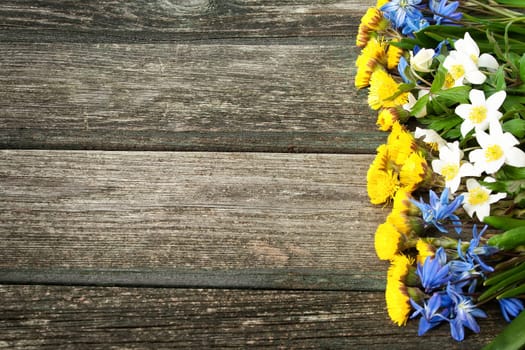 different sring flowers on old wooden background