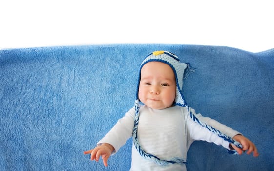 four month old baby in owl hat on a towel