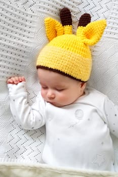 little boy sleeping on soft white blanket