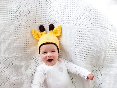 little boy lying on soft white blanket