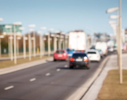 Blurred background of cars on asphalt road